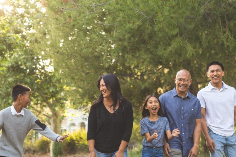 family is outside in nature enjoying time together and understanding the importance of family therapy